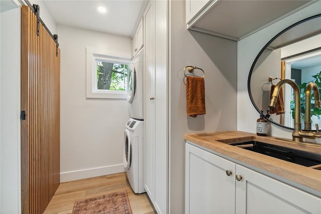 314 Hamilton St, Benton, NY 14527 - washroom featuring stacked washer / drying machine, light wood-style floors, cabinet space, recessed lighting, and baseboards