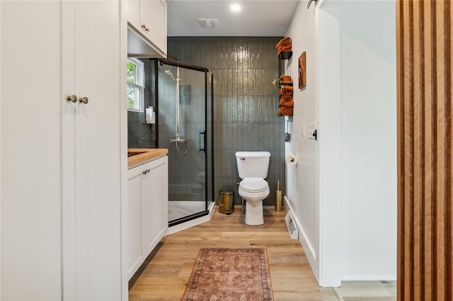 314 Hamilton St, Benton, NY 14527 - full bathroom with a stall shower, wood finished floors, toilet, baseboards, and vanity