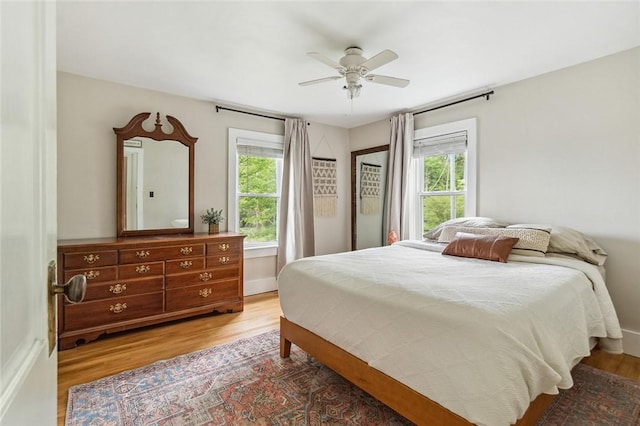 314 Hamilton St, Benton, NY 14527 - bedroom with multiple windows, wood finished floors, a ceiling fan, and baseboards