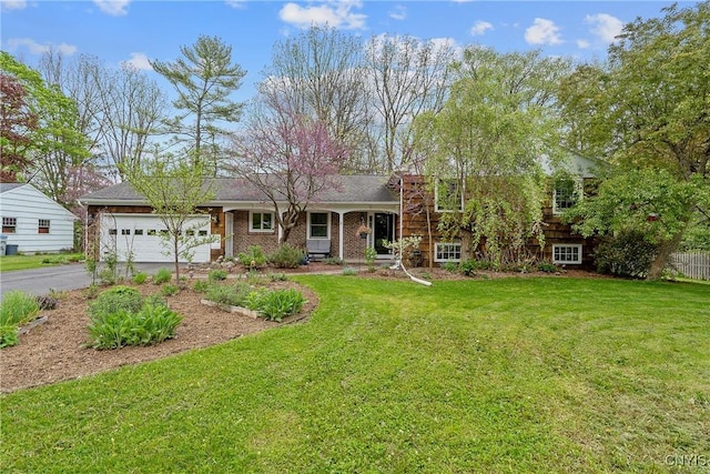 9 Bishop Dr, Manlius, NY 13066 - tri-level home featuring an attached garage, asphalt driveway, and a front lawn
