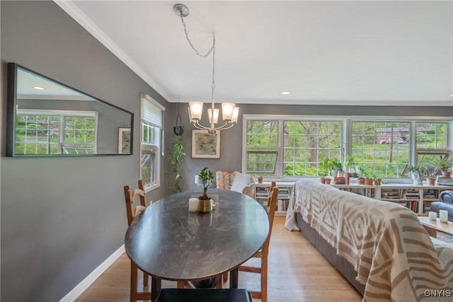 9 Bishop Dr, Manlius, NY 13066 - dining area with crown molding, a chandelier, plenty of natural light, baseboards, and wood finished floors