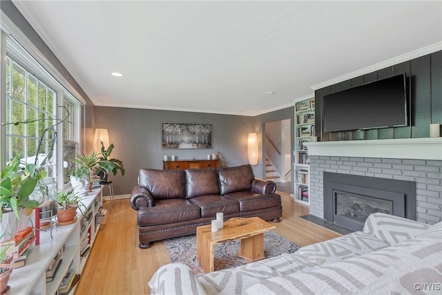 9 Bishop Dr, Manlius, NY 13066 - living room featuring wood finished floors, baseboards, ornamental molding, a fireplace, and recessed lighting