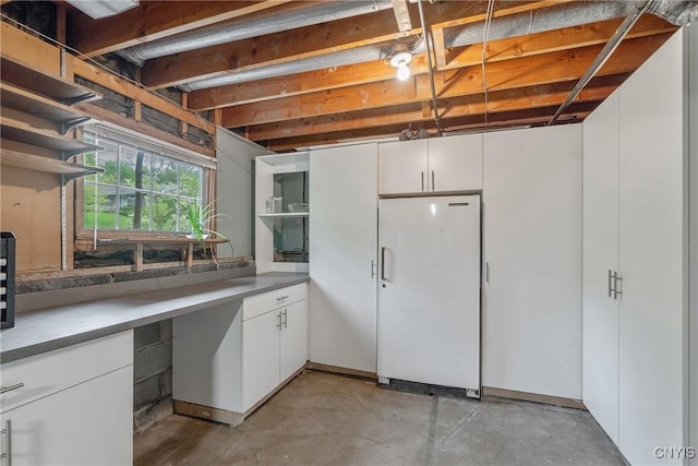 9 Bishop Dr, Manlius, NY 13066 - kitchen featuring freestanding refrigerator, open shelves, concrete floors, and white cabinetry