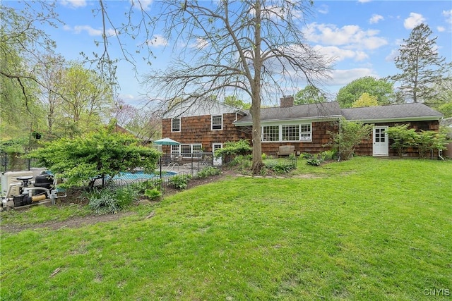 9 Bishop Dr, Manlius, NY 13066 - back of house featuring a chimney, a yard, an outdoor pool, and a patio
