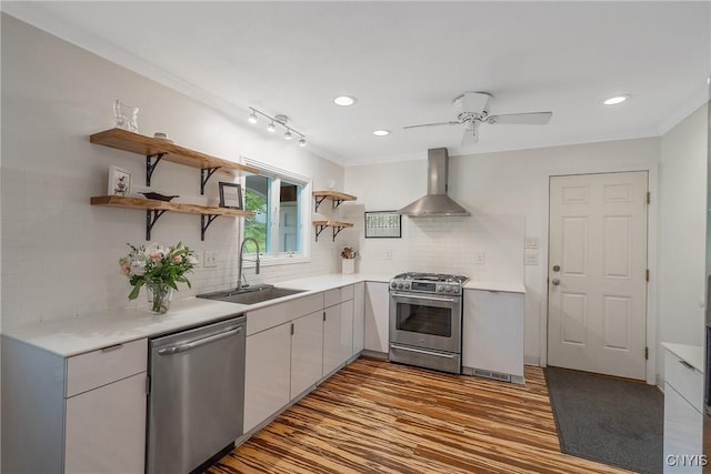 9 Bishop Dr, Manlius, NY 13066 - kitchen with wall chimney range hood, appliances with stainless steel finishes, a sink, open shelves, and light countertops