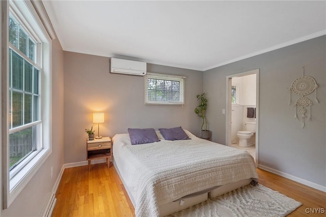 9 Bishop Dr, Manlius, NY 13066 - bedroom featuring a wall unit AC, light wood-style floors, baseboards, ensuite bathroom, and crown molding