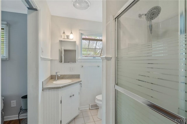 9 Bishop Dr, Manlius, NY 13066 - full bath featuring toilet, a shower stall, wainscoting, vanity, and tile patterned floors