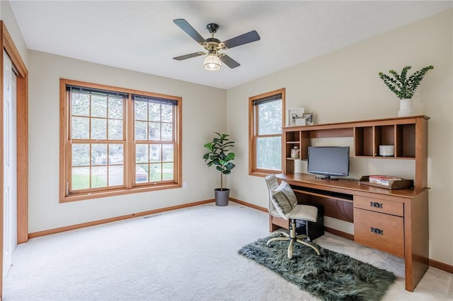 office with light colored carpet, baseboards, and ceiling fan