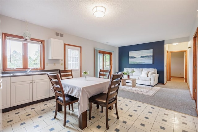 dining space featuring a textured ceiling