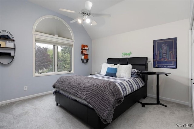 bedroom with carpet flooring, vaulted ceiling, baseboards, and ceiling fan