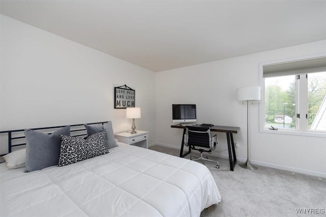 bedroom with carpet flooring and baseboards