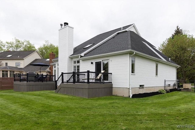 back of property with a deck, a chimney, and a shingled roof