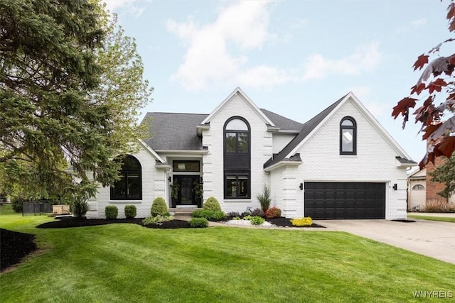 view of front facade with a garage, brick siding, concrete driveway, and a front yard
