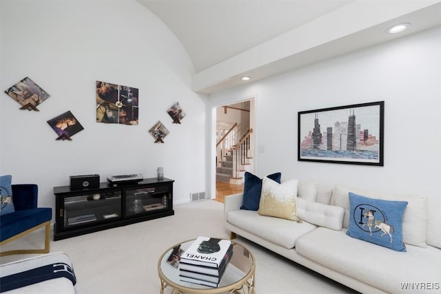 carpeted living area with stairs, vaulted ceiling, and recessed lighting