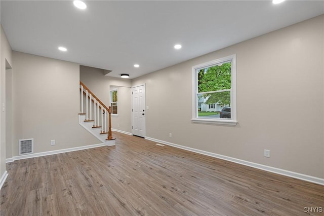 entrance foyer with baseboards, wood finished floors, stairs, and recessed lighting