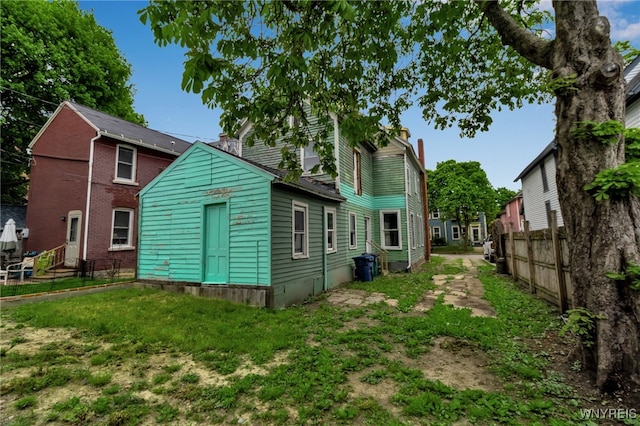 72 Mariner St, Buffalo, NY 14201 - back of house with fence and a chimney