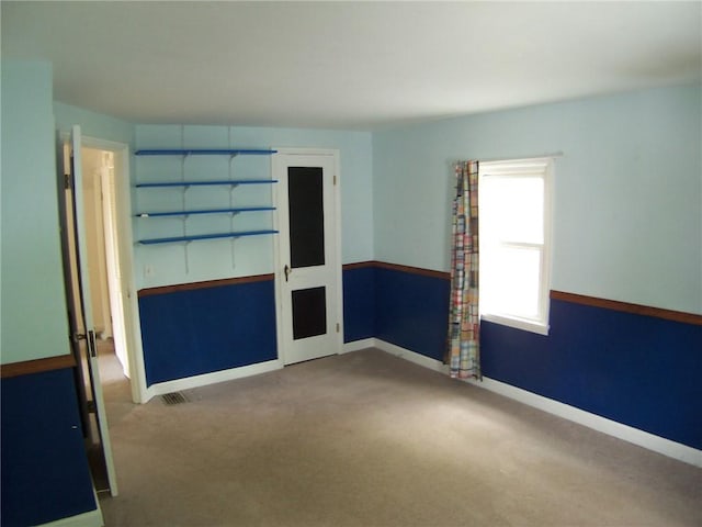 carpeted spare room with baseboards