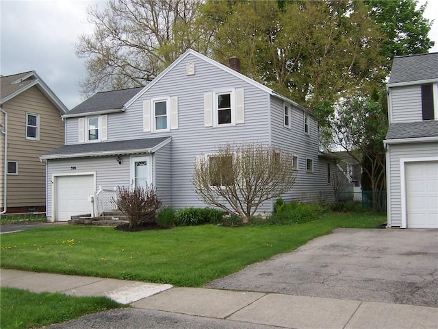 traditional-style home with a front yard and a garage