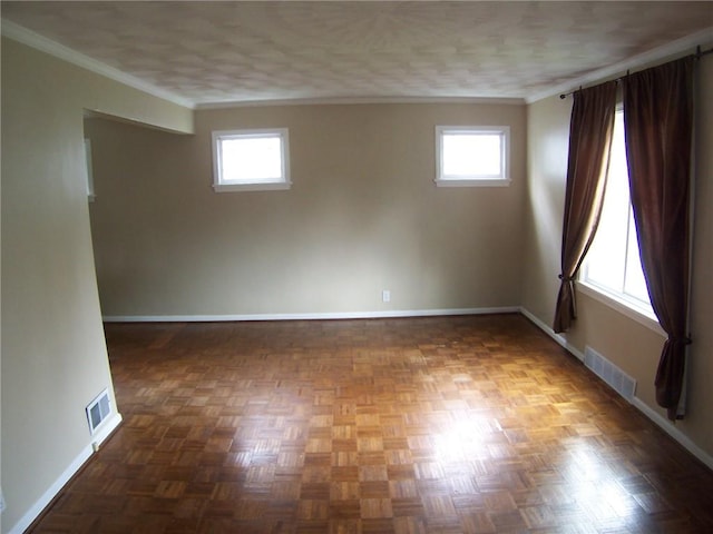 unfurnished room with baseboards, ornamental molding, and healthy amount of natural light