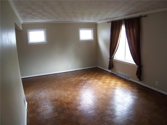 unfurnished room featuring ornamental molding and baseboards