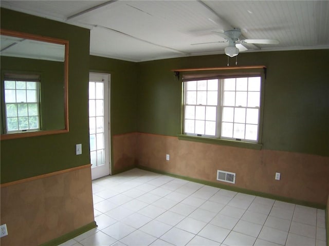 unfurnished room featuring a ceiling fan and wainscoting