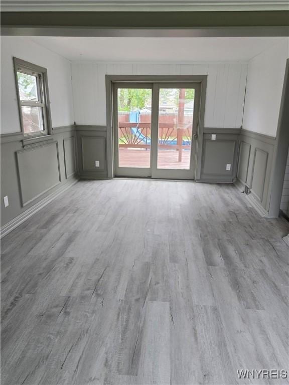 56 Gibbons St, Lackawanna, NY 14218 - unfurnished room with a decorative wall, plenty of natural light, wood finished floors, and wainscoting