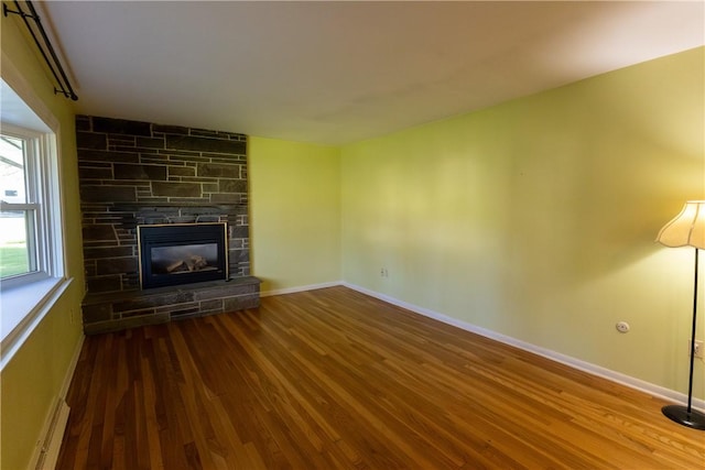 100 Parkview Dr, Erwin, NY 14870 - unfurnished living room featuring wood finished floors, a stone fireplace, and baseboards