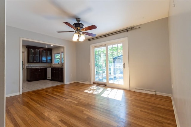 100 Parkview Dr, Erwin, NY 14870 - unfurnished living room featuring light wood-style floors, baseboards, a ceiling fan, and a sink