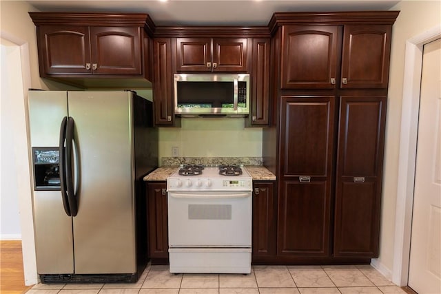 100 Parkview Dr, Erwin, NY 14870 - kitchen with appliances with stainless steel finishes, dark brown cabinetry, light tile patterned floors, and baseboards
