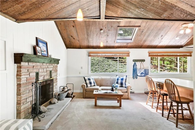 carpeted living area featuring wooden ceiling, a stone fireplace, lofted ceiling, and baseboards