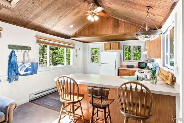 kitchen with freestanding refrigerator, black microwave, lofted ceiling, baseboard heating, and wood ceiling