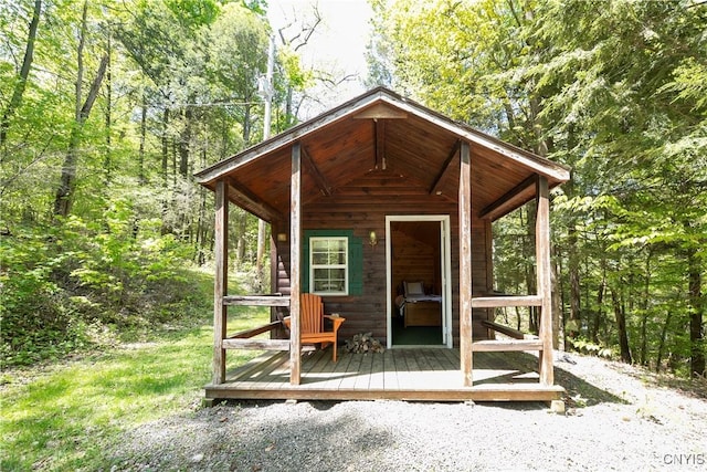view of outbuilding featuring an outdoor structure and a forest view