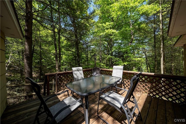 wooden deck featuring outdoor dining area