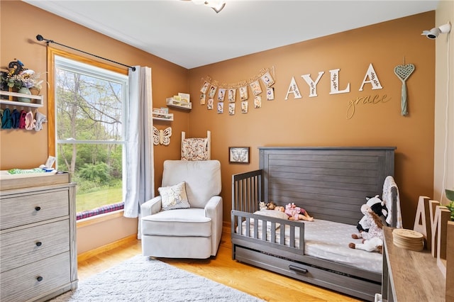 3760 N Creek Rd, Palmyra, NY 14522 - bedroom with a nursery area, wood finished floors, and baseboards