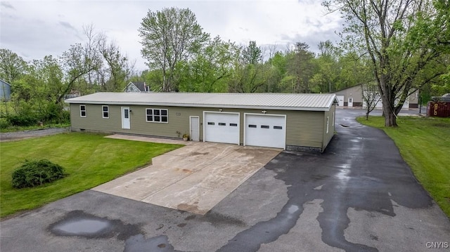 7498 Roberts St, Lenox, NY 13032 - view of front facade with a front yard, asphalt driveway, a metal roof, and a garage