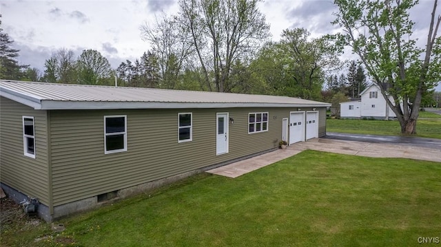 7498 Roberts St, Lenox, NY 13032 - rear view of property with a garage, a yard, and a metal roof