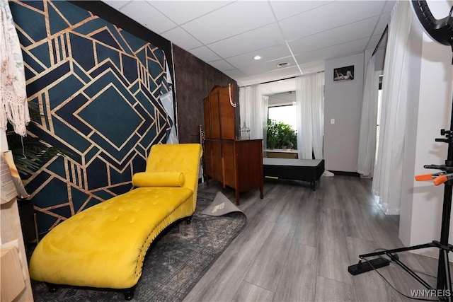 2282 Seneca St, Buffalo, NY 14210 - living area featuring wood finished floors, a paneled ceiling, and recessed lighting