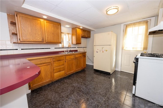 2282 Seneca St, Buffalo, NY 14210 - kitchen with freestanding refrigerator, gas stove, a sink, open shelves, and brown cabinetry