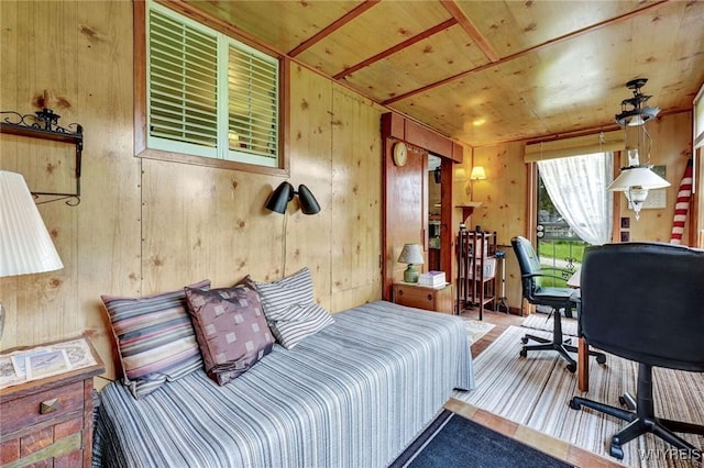 bedroom with wooden walls, access to outside, a desk, and wood ceiling
