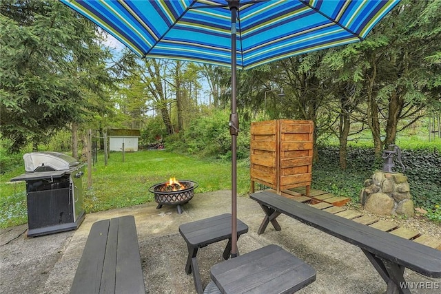 view of patio with an outdoor fire pit and area for grilling