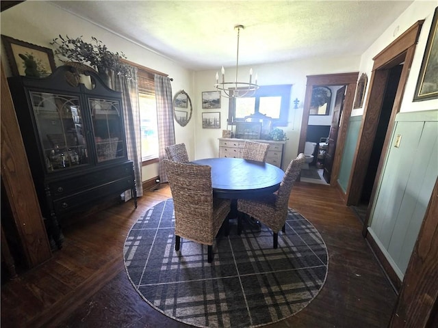 119 Verona St, Elmira, NY 14903 - dining space featuring dark wood-type flooring, a chandelier, and baseboards