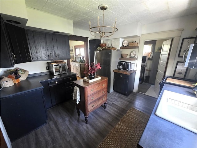 119 Verona St, Elmira, NY 14903 - kitchen with appliances with stainless steel finishes, dark wood-type flooring, a chandelier, dark cabinets, and open shelves