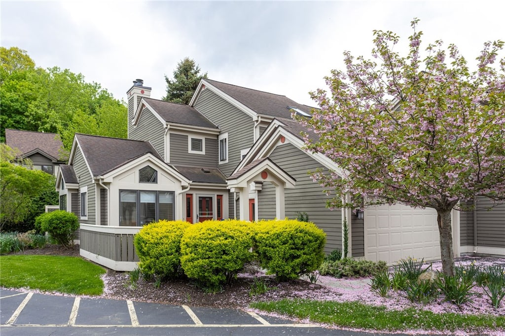 245 Highland Pkwy, Rochester, NY 14620 - view of front of property featuring a garage, a shingled roof, and a chimney