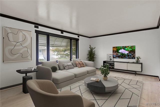 living area with light wood-type flooring, crown molding, and baseboards