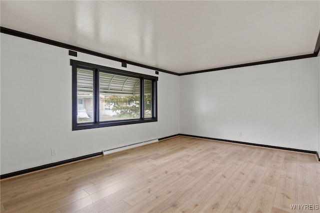 spare room with a baseboard radiator, ornamental molding, light wood-type flooring, and baseboards