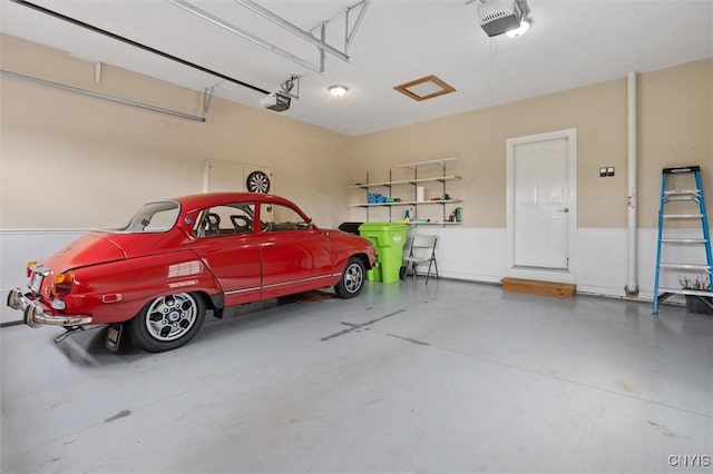 119 Star Gaze Cir, Manlius, NY 13066 - garage with a garage door opener and a wainscoted wall