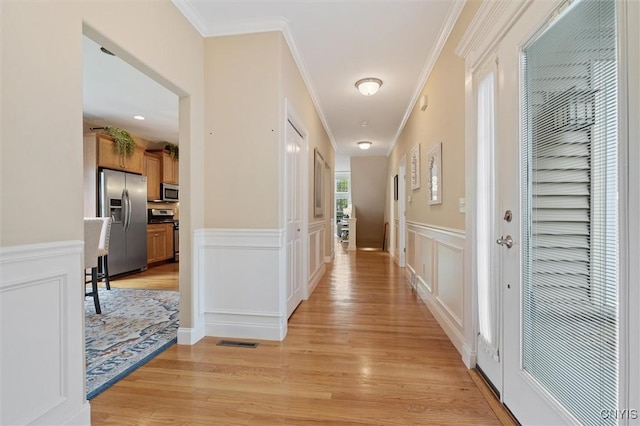 119 Star Gaze Cir, Manlius, NY 13066 - hallway with light wood-type flooring, a decorative wall, ornamental molding, and a wainscoted wall