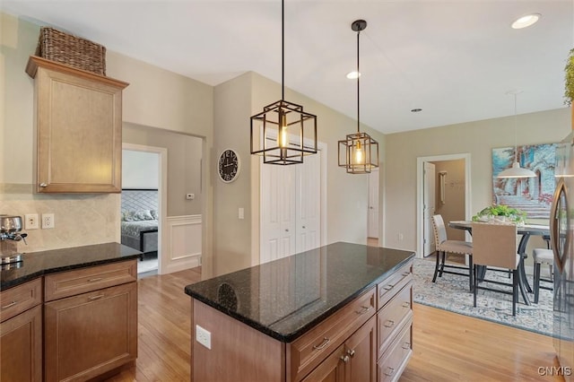 119 Star Gaze Cir, Manlius, NY 13066 - kitchen featuring light wood-style flooring, backsplash, dark stone countertops, hanging light fixtures, and recessed lighting