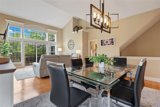 119 Star Gaze Cir, Manlius, NY 13066 - dining room with wood finished floors, high vaulted ceiling, a chandelier, and baseboards