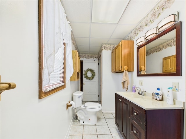 bathroom with tile patterned flooring, baseboards, toilet, and vanity